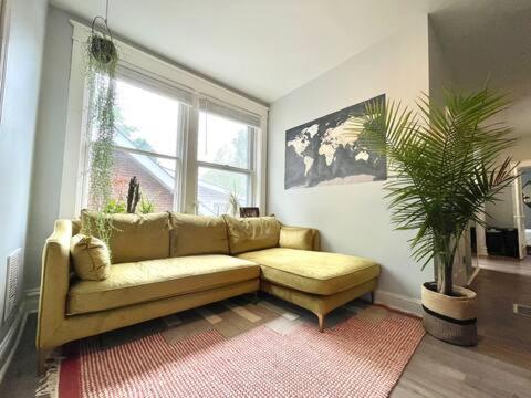 a living room with a couch and a window at Cute Neighborhood Rainbow Apt in Saint Louis
