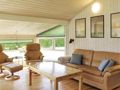 a living room with a couch and a coffee table at 4 star holiday home in Hals in Hals