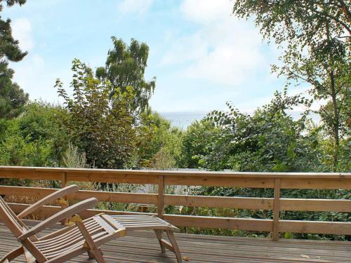 a pair of chairs sitting on a wooden deck at 6 person holiday home in Rudkøbing-By Traum in Spodsbjerg