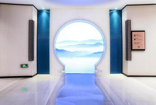an archway in a room with a blue hallway at Xiamen Jingmin Central Hotel in Xiamen