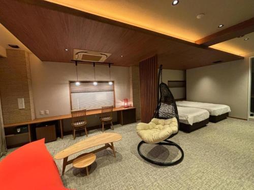 a hotel room with a bedroom with a hammock in it at Meitei no Yado Hotel Koshien in Fuefuki