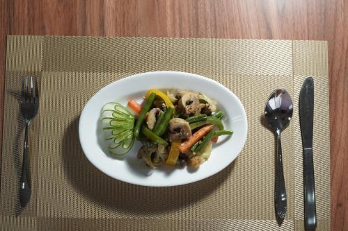 a plate of food with vegetables on a table at RIshikulam Wellness Centre in Samālkha