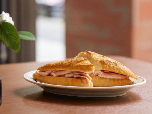 a sandwich on a plate on a table at FAV LUX Sapporo Susukino in Sapporo