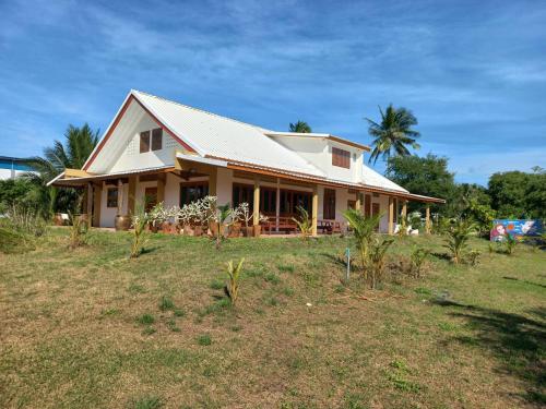 a house in a field with palm trees at Beach Front Villa, Saphli beach, Chumphon,Thailand in Ban Tha Samet (1)
