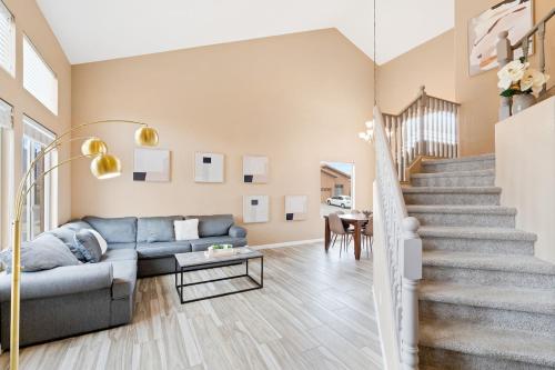 a living room with a couch and a staircase at Perfect Escape with Epic Views in Tucson