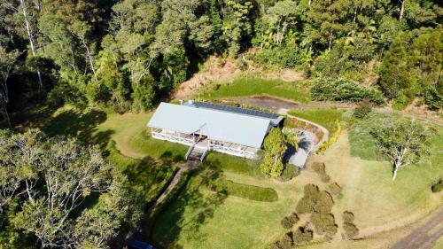 an aerial view of a house in the middle of a forest at Nightcap Ridge - Byron Bay Hinterland in Dorroughby