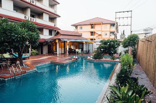 a large swimming pool in front of a building at Gazebo Resort Pattaya in Pattaya Central