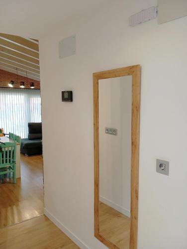 a mirror on a wall in a living room at La Casita de Suances 2 Ideal Familias y Mascotas in Suances