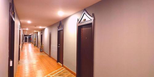 a corridor of a hallway with a long hallway at Gazebo Resort Pattaya in Pattaya Central