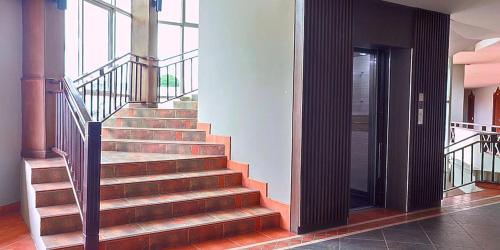 a stairway in a building with a stair case at Gazebo Resort Pattaya in Pattaya Central