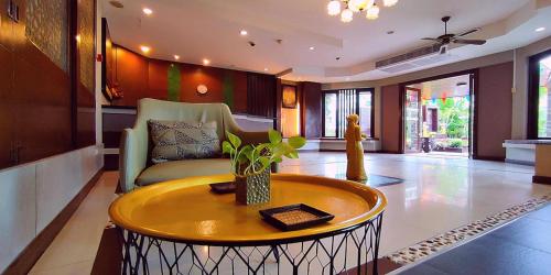 a living room with a couch and a table at Gazebo Resort Pattaya in Pattaya Central