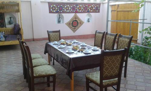a table with bowls and plates on top of it at Guest House Orzu in Khiva
