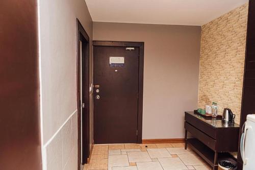 a hallway with a black door in a room at Gazebo Resort Pattaya in Pattaya Central