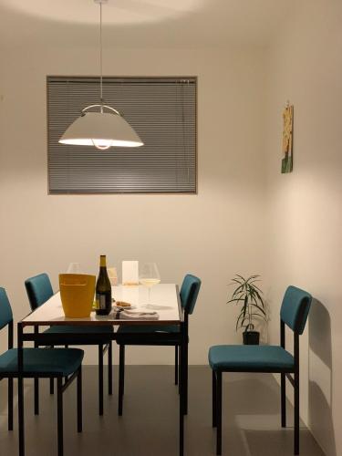 a dining room with a table and blue chairs at 스테이지안 in Daegu