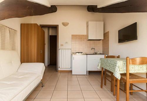 a kitchen and a living room with a couch and a table at Centrale Torino in Turin
