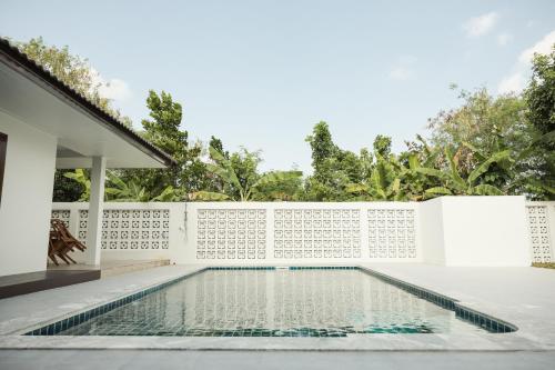 a swimming pool in the backyard of a house at จงเจริญเฮ้าส์ Jongcharoen's house 