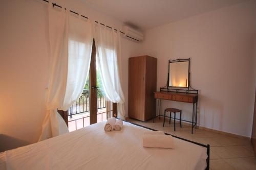 a bedroom with a bed with a mirror and a window at Eden Apartments in Neo Klima