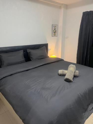 a bedroom with a bed with a towel on it at Lagoon vibes in Pattaya Central