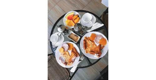 an overhead view of a table with plates of breakfast foods at Karen Plains Hotel Nairobi in Nairobi