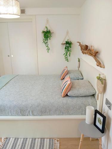 a bedroom with a bed and a table at La Casita de Suances 2 Ideal Familias y Mascotas in Suances
