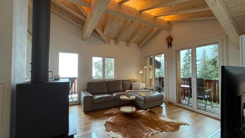 a living room with a couch and a tv at am Bärgbach DG in Bettmeralp