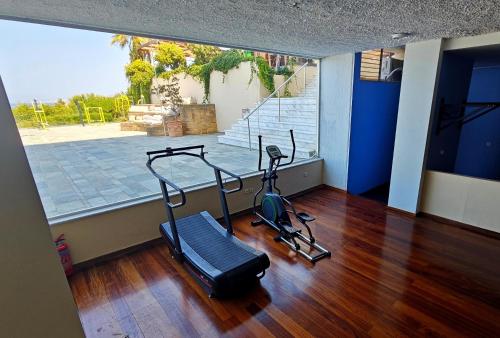 a gym with two exercise bikes in a room at Leptos Panorama Hotel in Kalamaki Chanion