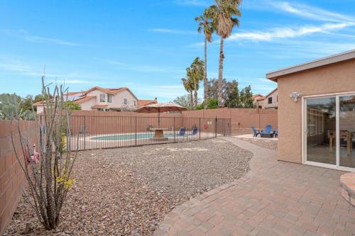 a backyard with a fence and palm trees at Perfect Escape with Epic Views in Tucson