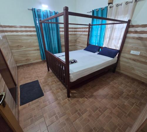 a bedroom with a canopy bed in a room at Wayanad views in Vythiri