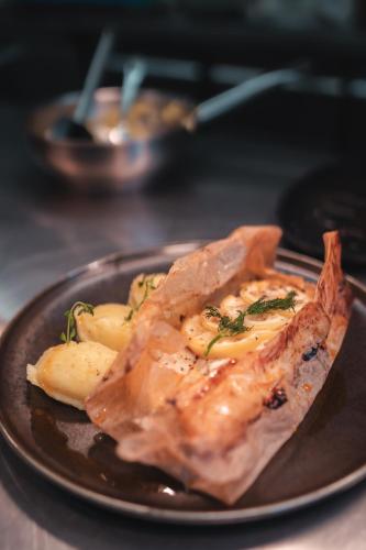 a plate of food with meat and potatoes on a table at Hotel Alpensonne - Panoramazimmer & Restaurant in Arosa