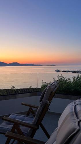 a chair sitting on a patio with a view of the water at Osservatorio House in Laganas