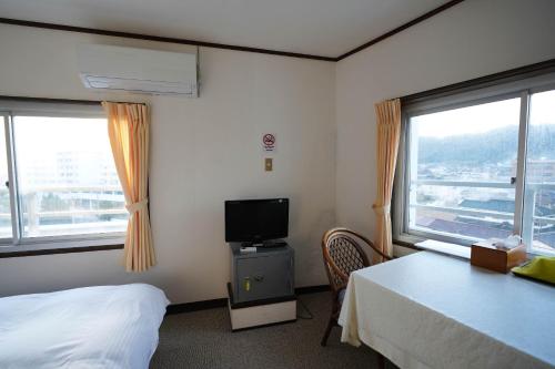 Ένα ή περισσότερα κρεβάτια σε δωμάτιο στο Grand Hotel Taiyo