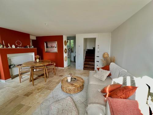 a living room with a couch and a table at Maison Simone in Samois-sur-Seine