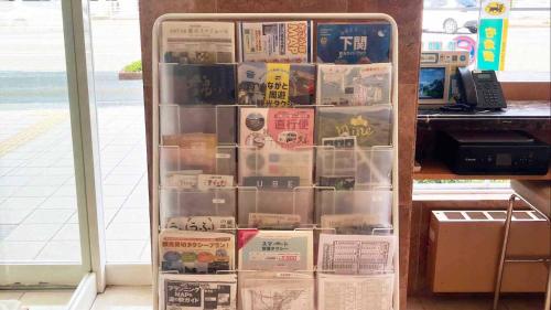 a refrigerator full of books in a room at Toyoko Inn Shin-yamaguchi-eki Shinkansen-guchi in Yamaguchi