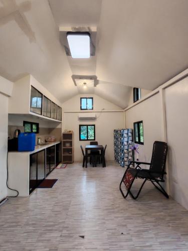 a large room with a kitchen and a table at Loong transient house in San Antonio