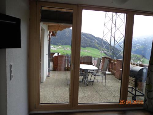 a view of a balcony with a table and chairs at Gästehaus Flörl in Gerlosberg