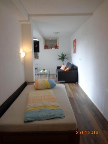 a living room with a bed in the middle of a room at Gästehaus Flörl in Gerlosberg