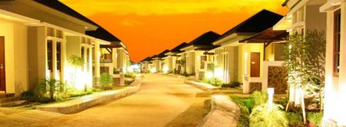 a row of houses on a street at night at The Luxio Hotel in Sorong