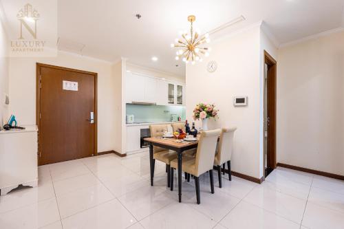 a kitchen and dining room with a table and chairs at The Peak Suite at Landmark Plus in Ho Chi Minh City