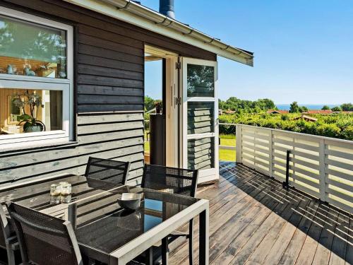 a wooden deck with a table and chairs on a house at 6 person holiday home in Sydals in Sarup