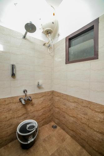 a bathroom with a shower with a fan and a sink at Interlaken - 4 BR VIlla in Yedapalli
