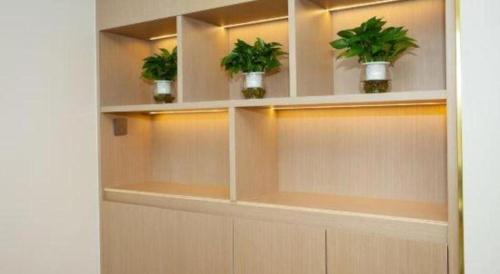 a room with shelves with potted plants on them at Lavande Hotel·Dongxing Port in Fangcheng