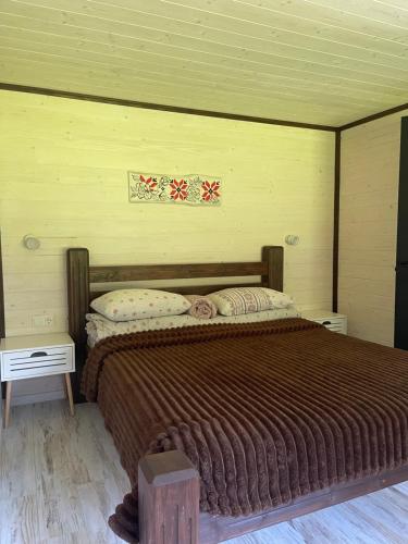 a bedroom with a large bed in a room at Барнхаус Карпатський подих in Krasnyy