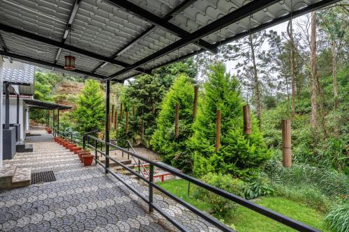 a balcony with a view of a forest at Interlaken in Yedapalli