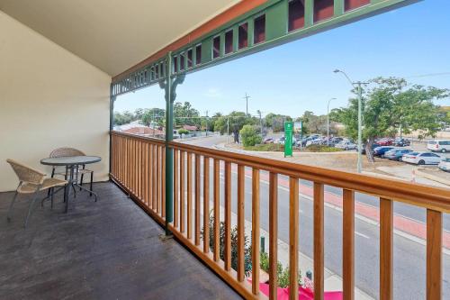 a balcony with a table and a view of a street at Quality Hotel Bayswater in Perth