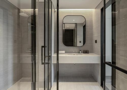 a bathroom with a sink and a mirror at The28 Residence in Hanoi