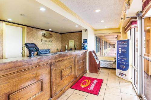 a bar in a restaurant with a red rug on the floor at Econo Lodge McAlester in McAlester
