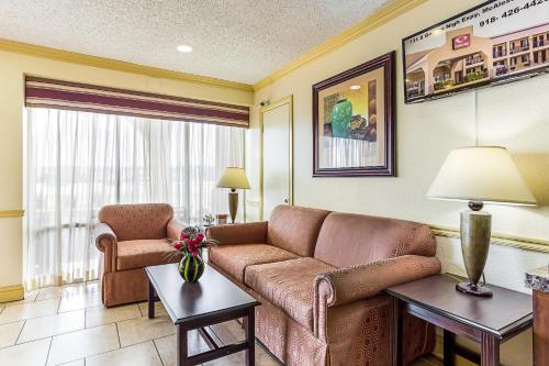 a living room with a couch and a chair at Econo Lodge McAlester in McAlester