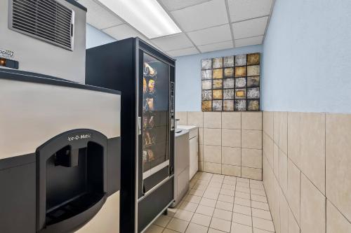 a bathroom with a refrigerator with a tv in it at Quality Inn Hixson-Chattanooga in Hixson