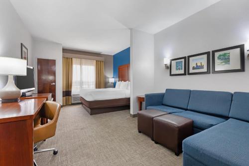 a hotel room with a couch and a bed at Comfort Suites DFW N-Grapevine in Grapevine