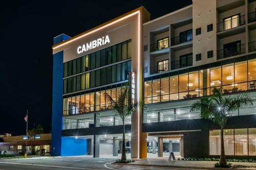 a building with the name of the hotel at night at Cambria Hotel St Petersburg-Madeira Beach Marina in St Pete Beach